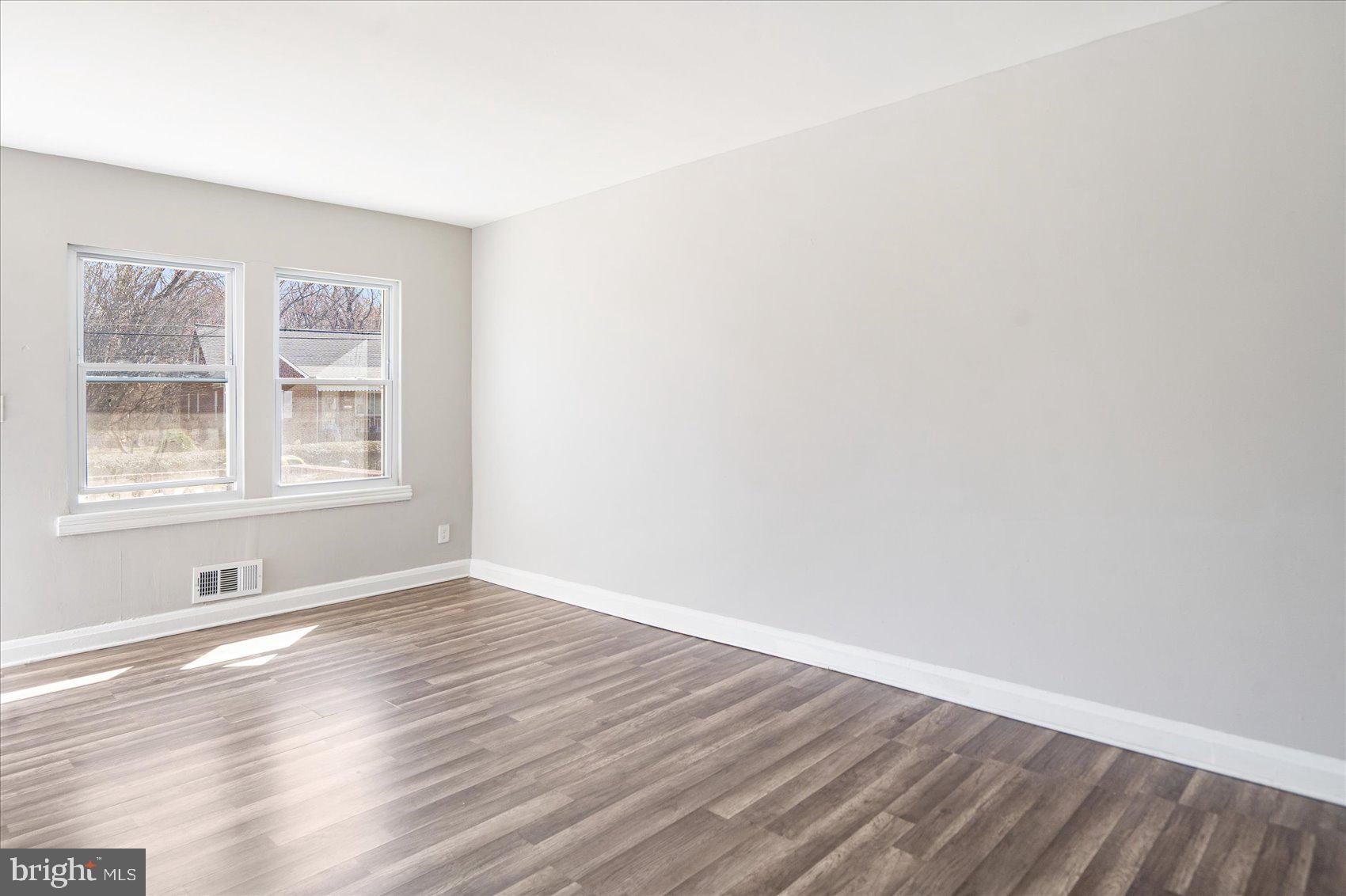 706 Norris Lane Baltimore, MD 21221 - Photo 11 of 36 a view of an empty room with wooden floor and a window