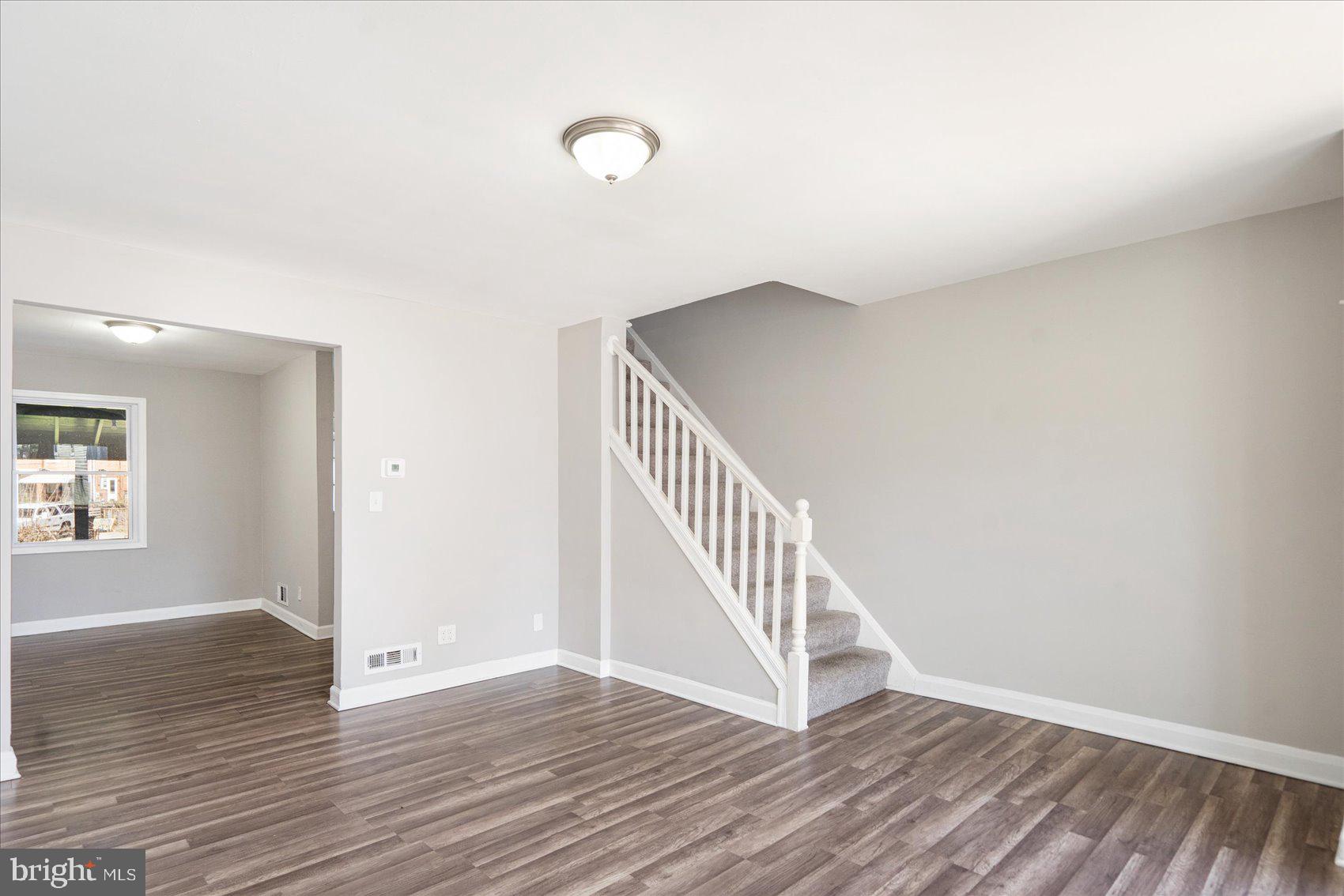 706 Norris Lane Baltimore, MD 21221 - Photo 12 of 36 wooden floor in a hall with an entryway and a window