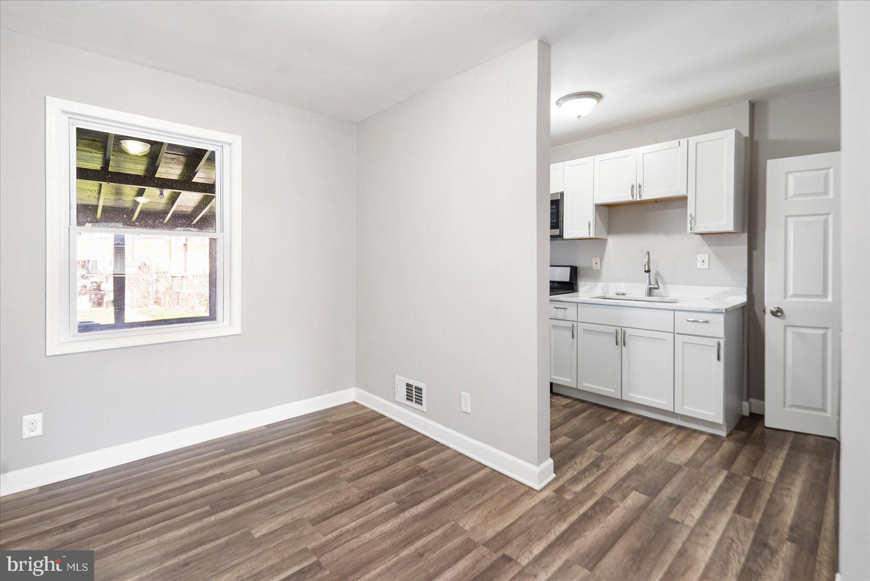 706 Norris Lane Baltimore, MD 21221 - Photo 15 of 36 a view of a kitchen with wooden floor and a sink