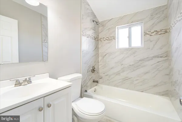 a bathroom with a toilet and a bathtub
