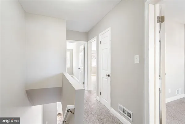 a view of a hallway with white walls