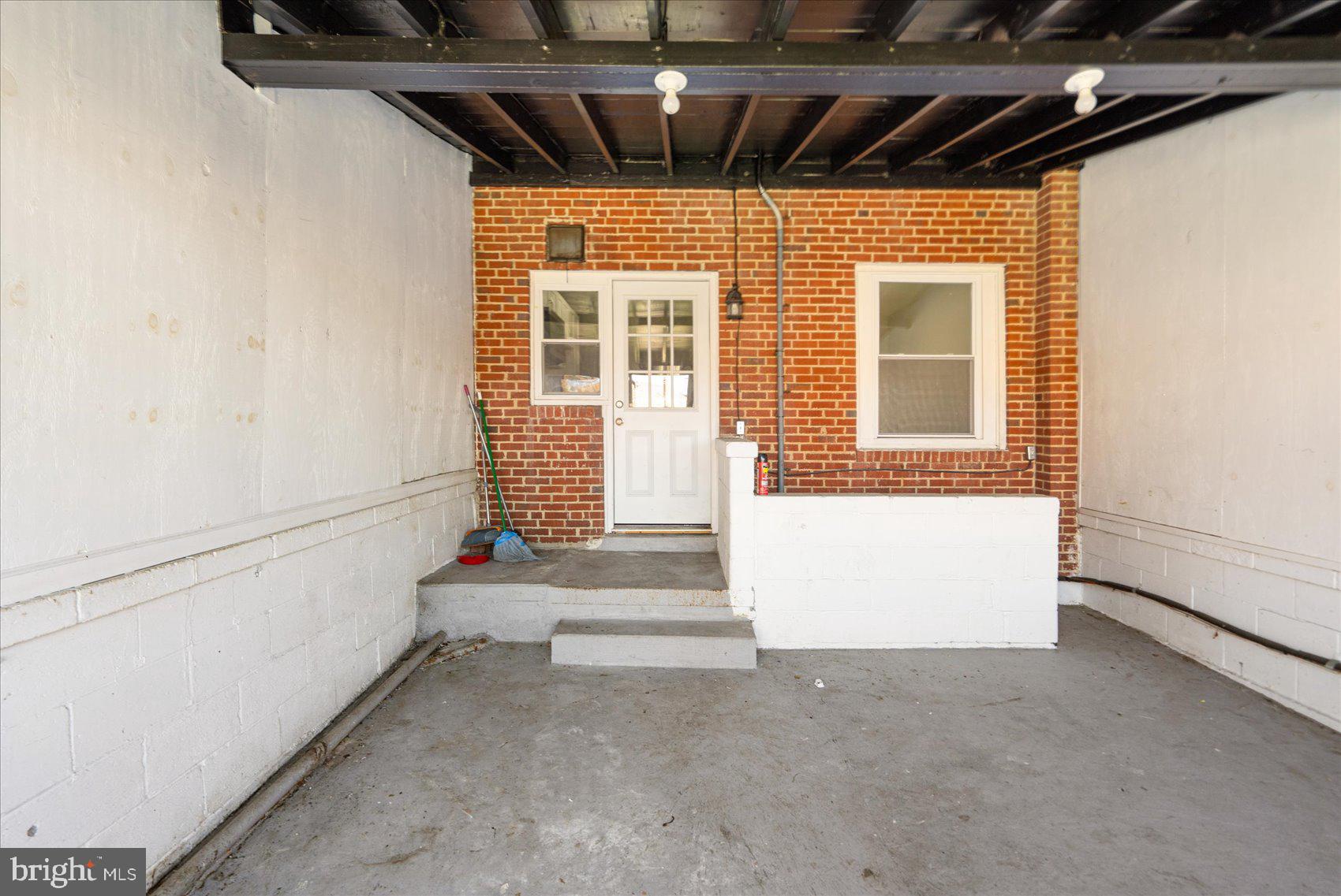 706 Norris Lane Baltimore, MD 21221 - Photo 5 of 36 a view of porch with a door and a refrigerator