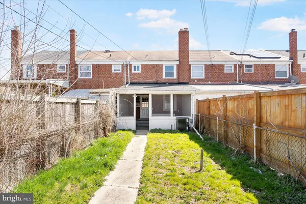 a view of a backyard with wooden fence