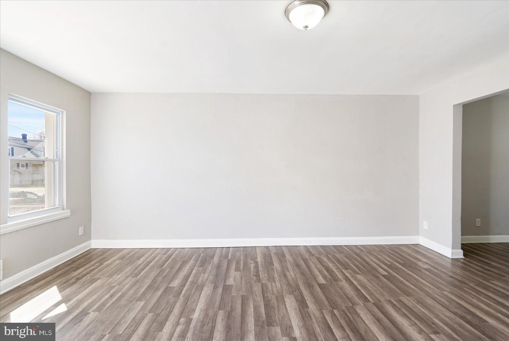 706 Norris Lane Baltimore, MD 21221 - Photo 10 of 36 a view of a room with wooden floor and white walls