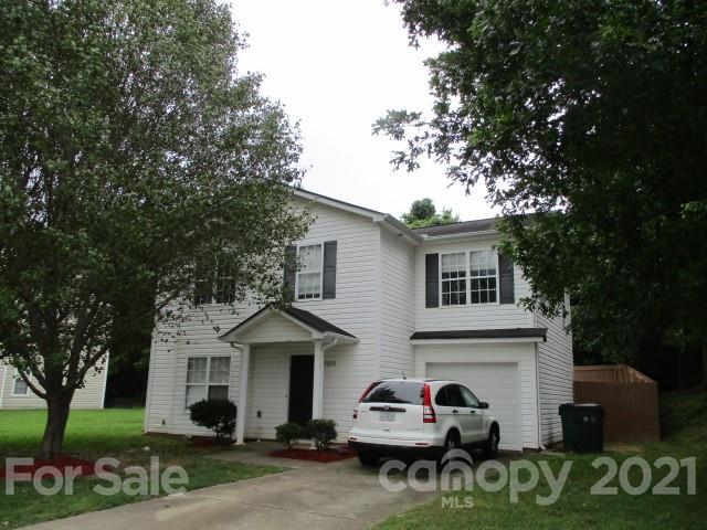 11002 Pointer Ridge Drive Charlotte, NC 28214 - Photo 1 of 2 a front view of a house with a garden and trees