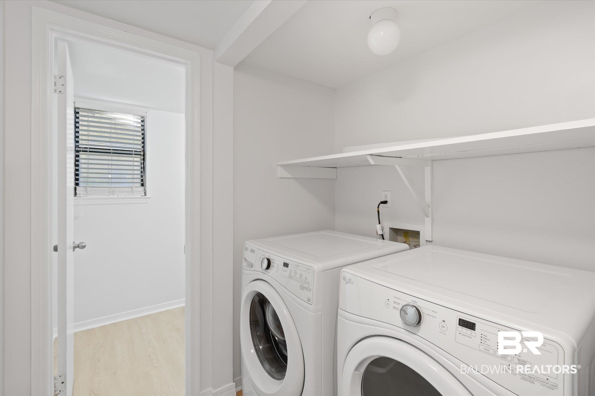 1008 Mcneil Avenue Mobile, AL 36609 - Photo 17 of 20 Washroom with washing machine and clothes dryer and light hardwood / wood-style floors