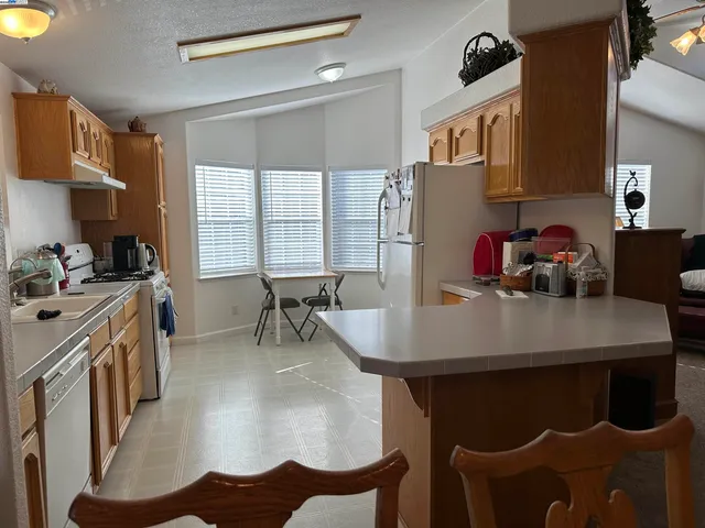 a dining room with furniture and a window