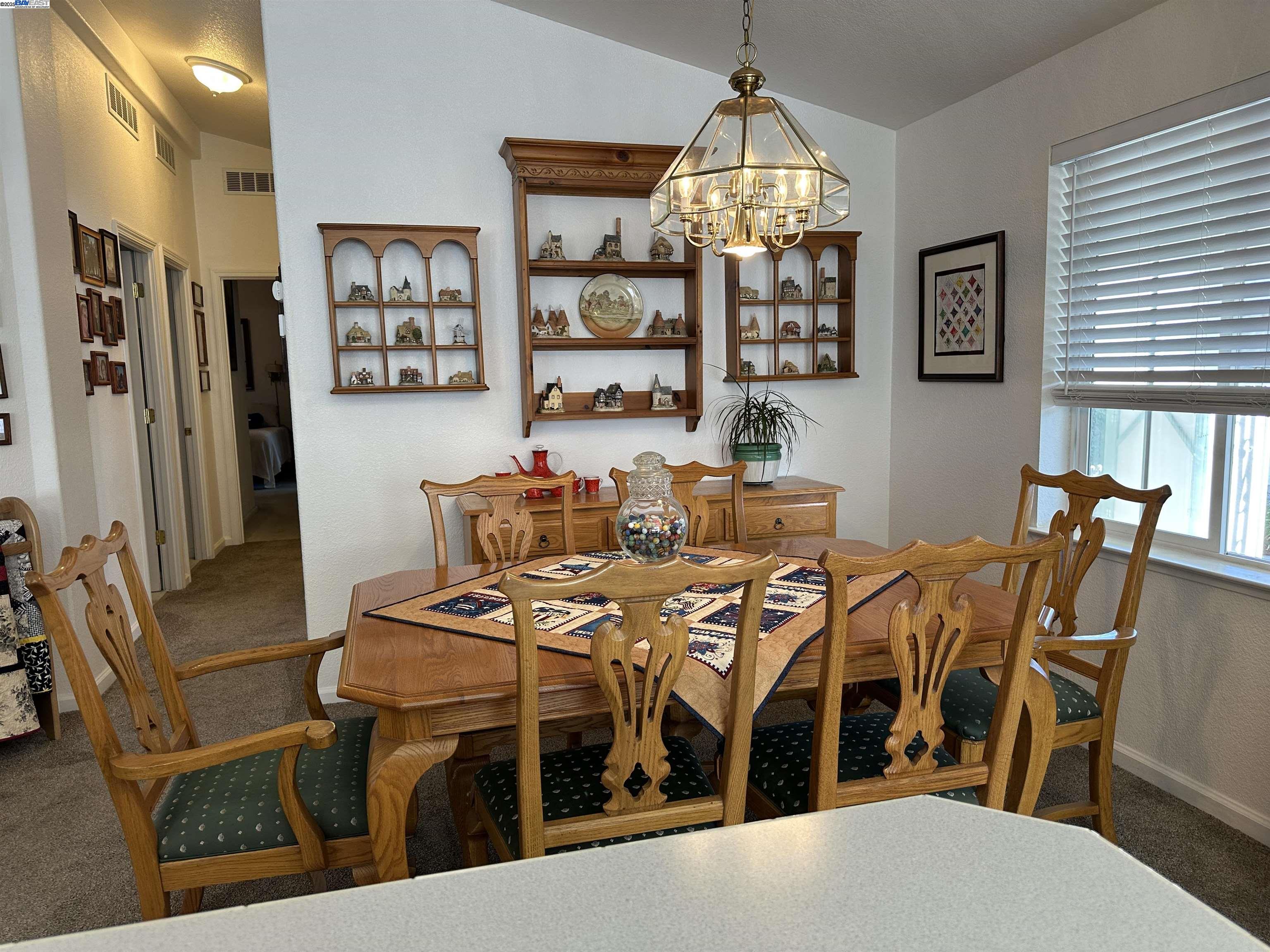 711 Old Canyon Road, Unit 103 Fremont, CA 94536 - Photo 15 of 38 a view of a dining room with furniture window and wooden floor