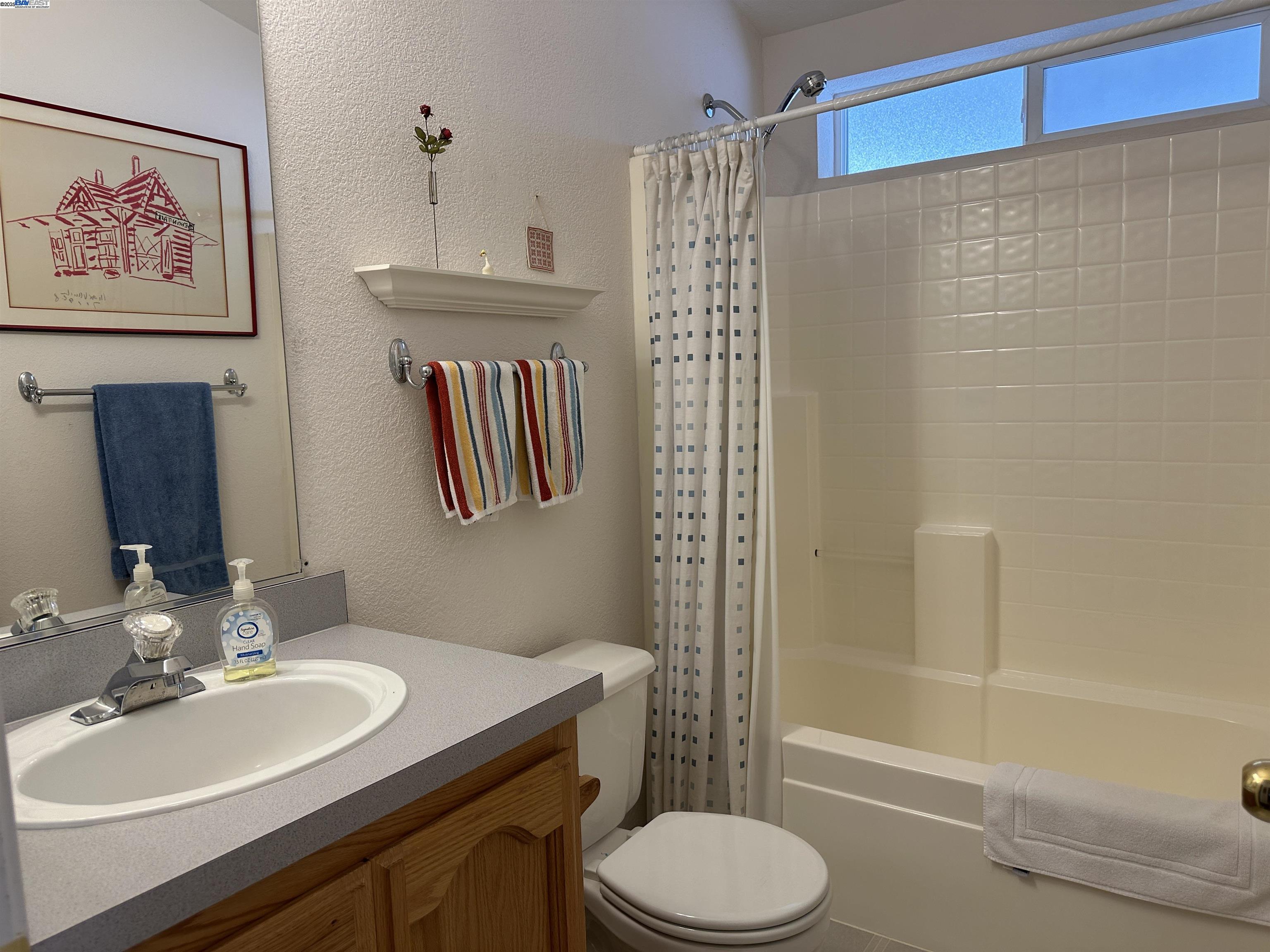 711 Old Canyon Road, Unit 103 Fremont, CA 94536 - Photo 19 of 38 a bathroom with a sink a toilet and shower