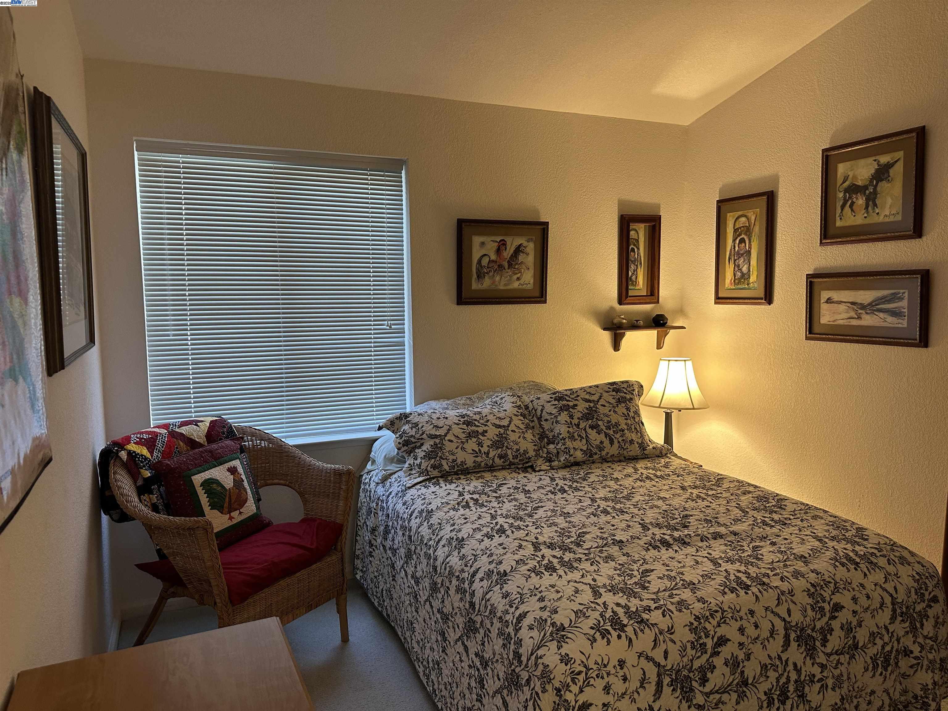 711 Old Canyon Road, Unit 103 Fremont, CA 94536 - Photo 20 of 38 a bedroom with a bed and wooden floor