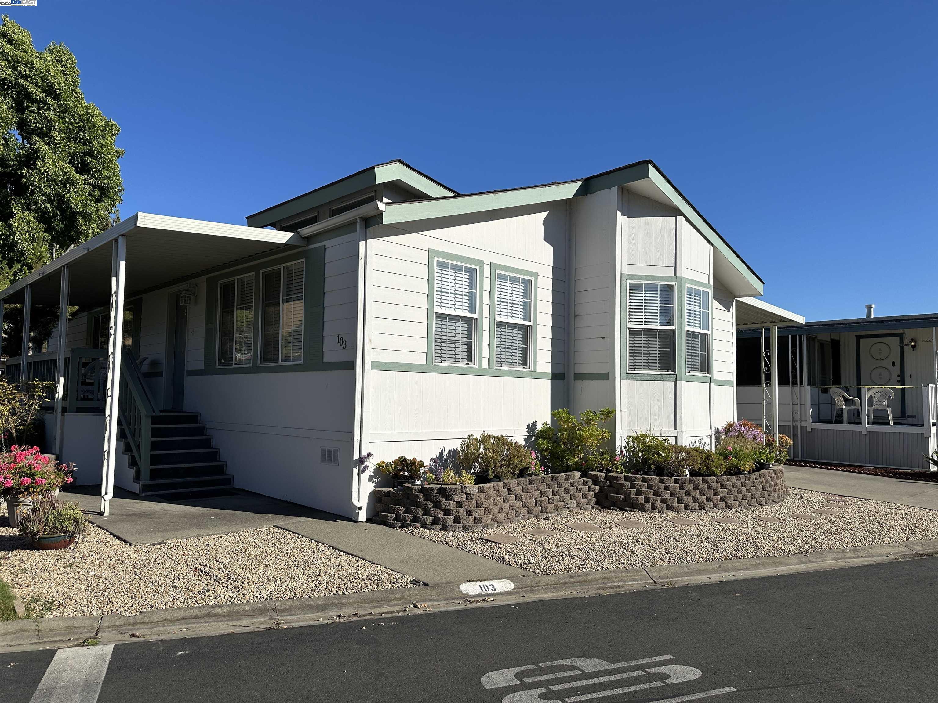 711 Old Canyon Road, Unit 103 Fremont, CA 94536 - Photo 2 of 38 a front view of a house with a yard