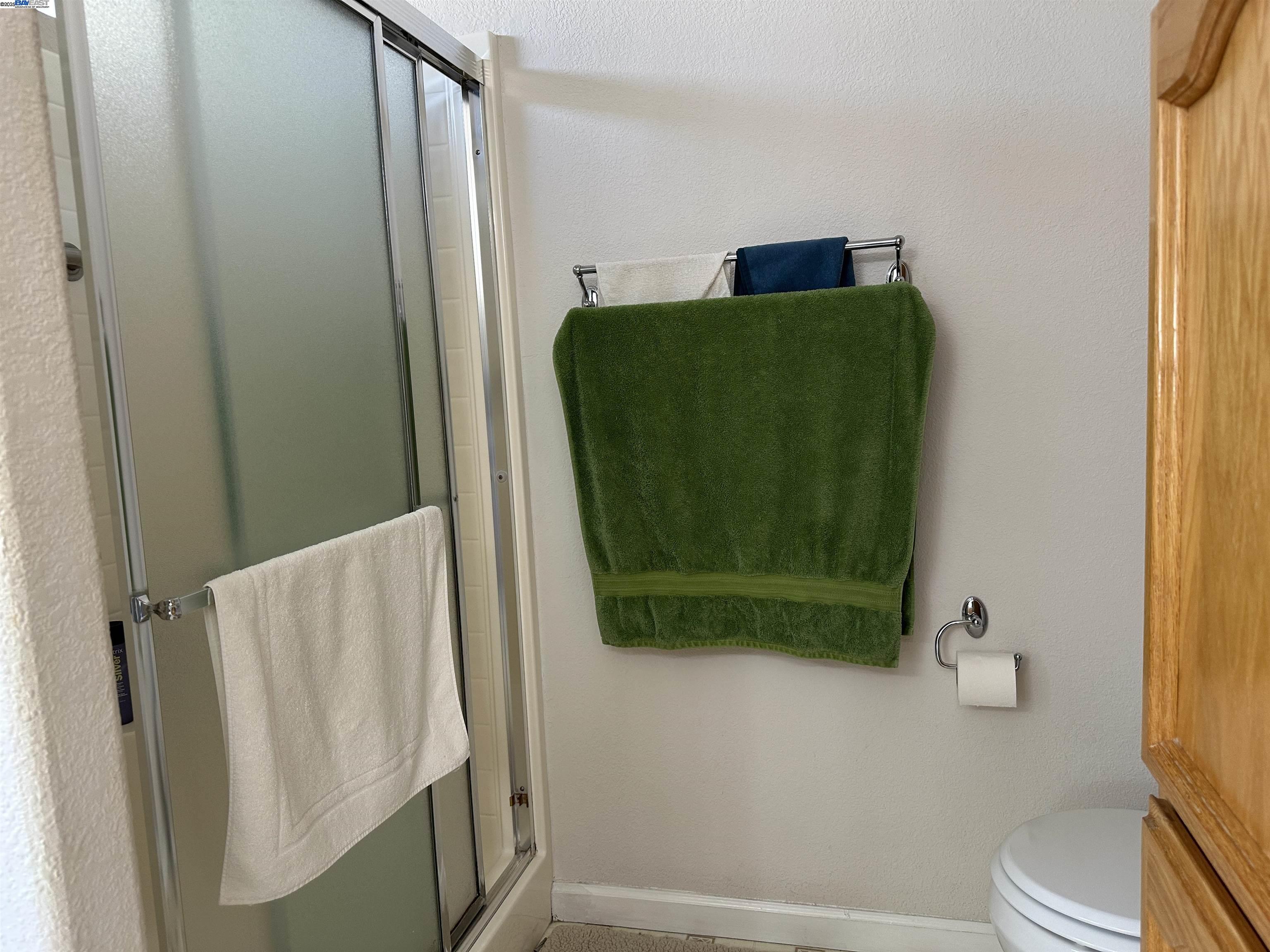 711 Old Canyon Road, Unit 103 Fremont, CA 94536 - Photo 25 of 38 a bathroom with a toilet and a shower