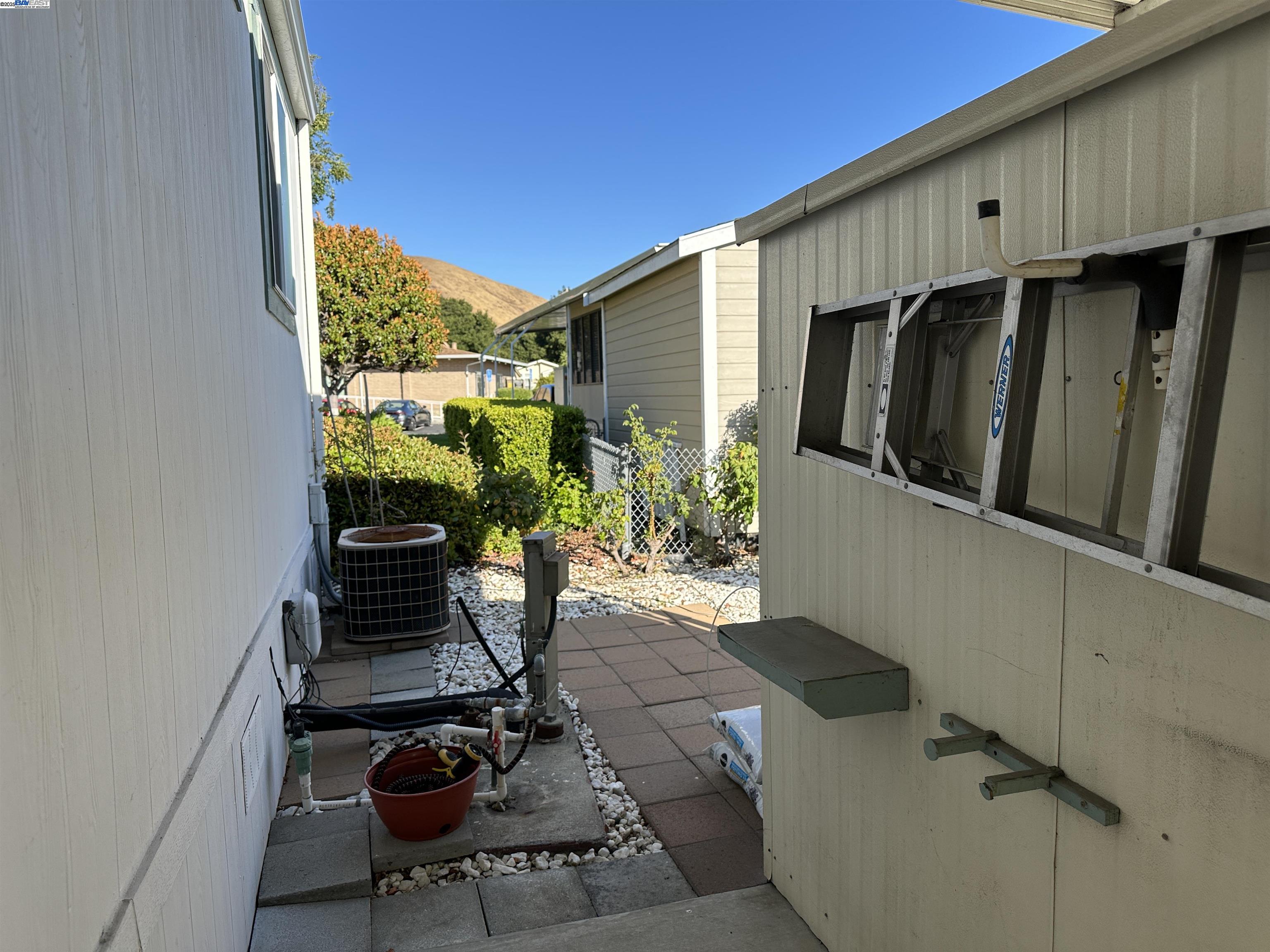 711 Old Canyon Road, Unit 103 Fremont, CA 94536 - Photo 30 of 38 a view of a balcony with chair and potted plants