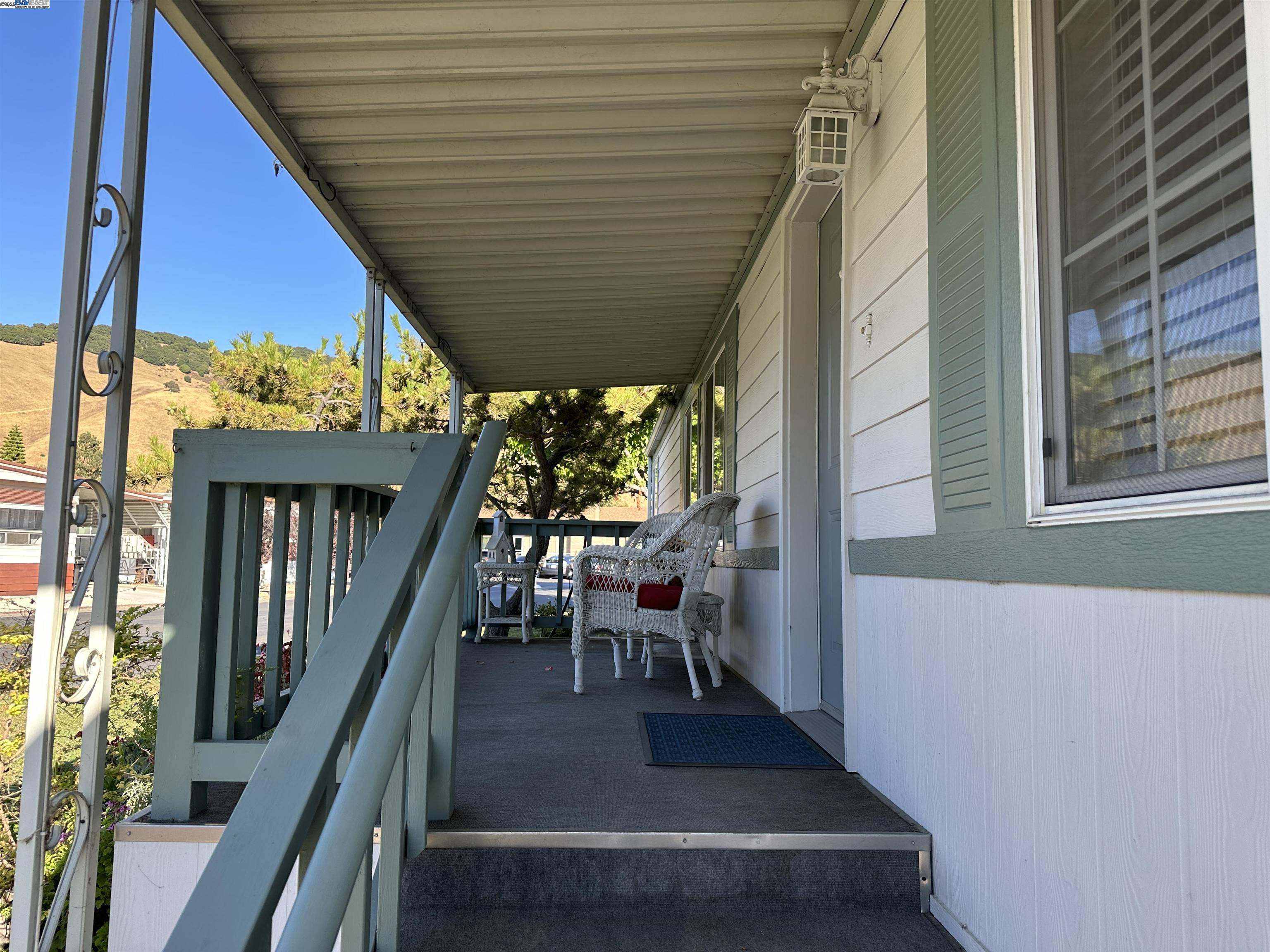 711 Old Canyon Road, Unit 103 Fremont, CA 94536 - Photo 3 of 38 a view of a patio with table and chairs and wooden floor