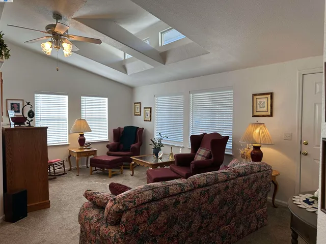 a view of a dining room with furniture and a chandelier