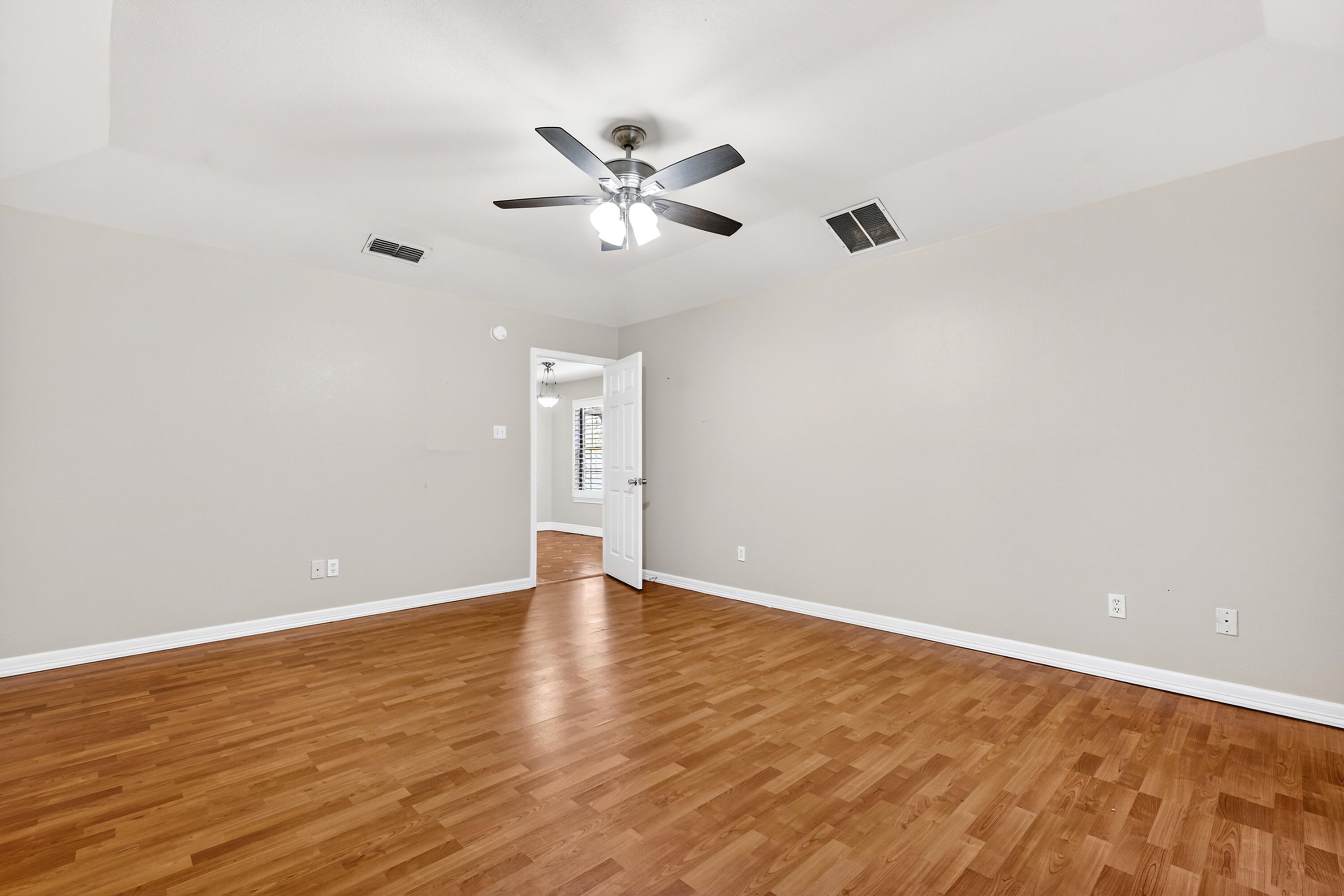 2415 93rd Street Lubbock, TX 79423 - Photo 13 of 24 a view of an empty room with wooden floor