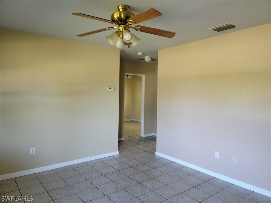 114 Florida Road Lehigh Acres, FL 33936 - Photo 5 of 12 a view of an empty room and window with a fan