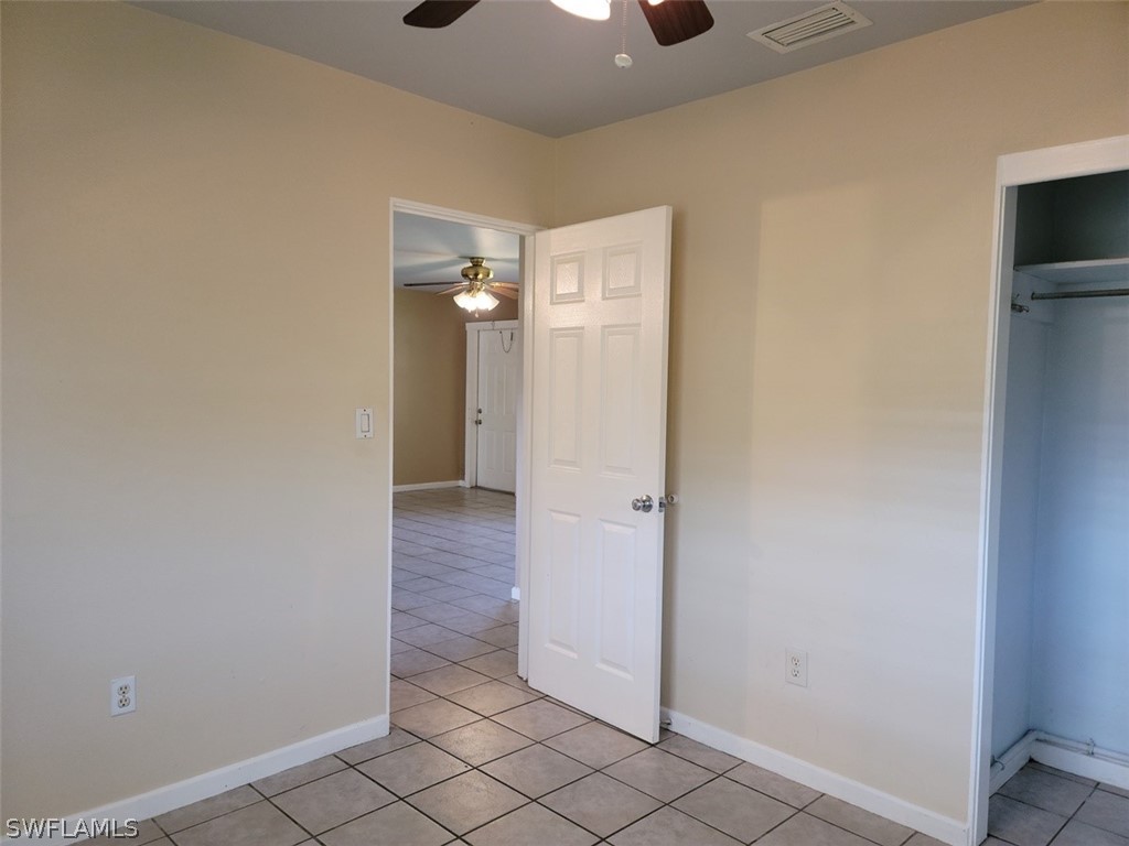 114 Florida Road Lehigh Acres, FL 33936 - Photo 6 of 12 a view of a hallway with wooden floor