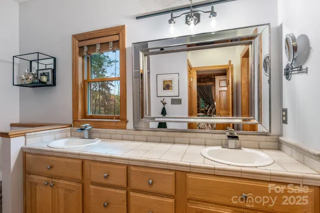 a work room with furniture a flat screen tv and a window