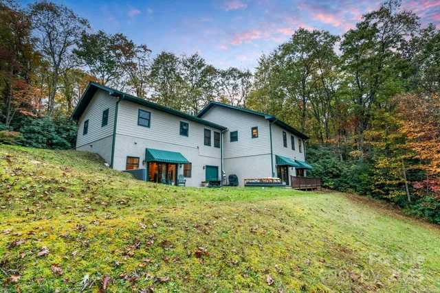a living room with furniture fireplace and a large window