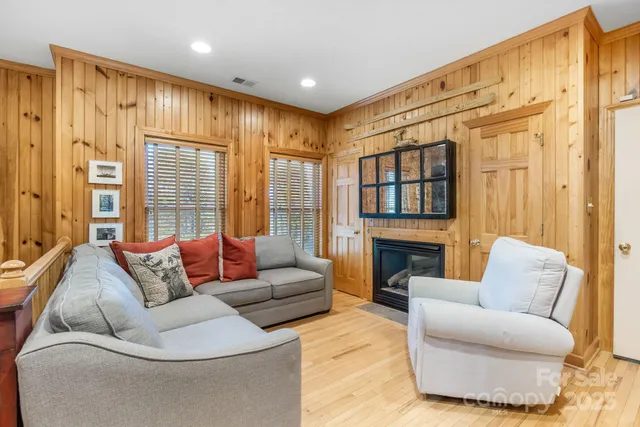 a living room with furniture a rug and a window
