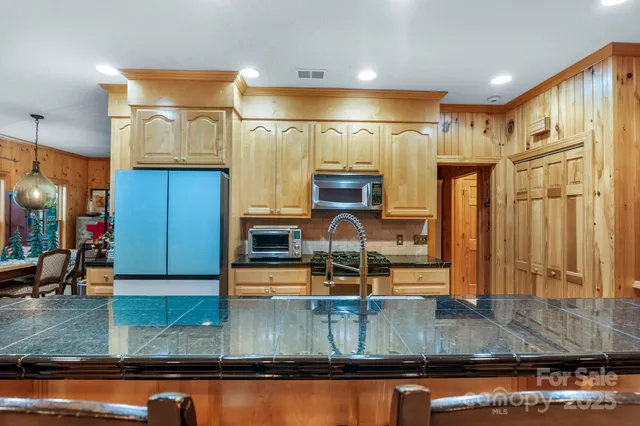 a living room filled with furniture and a chandelier