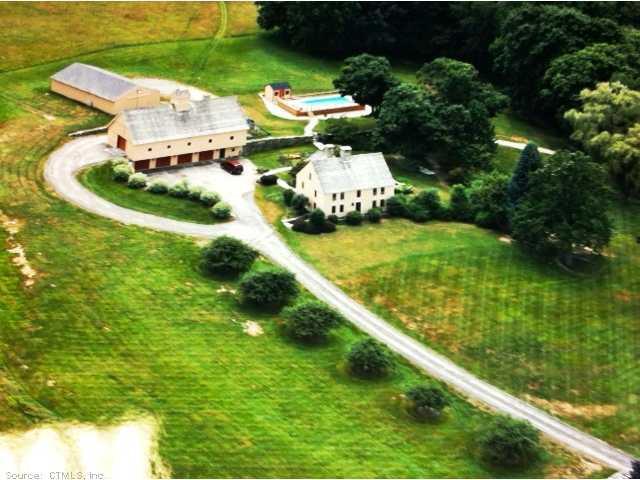 an aerial view of a house with a yard and lake view