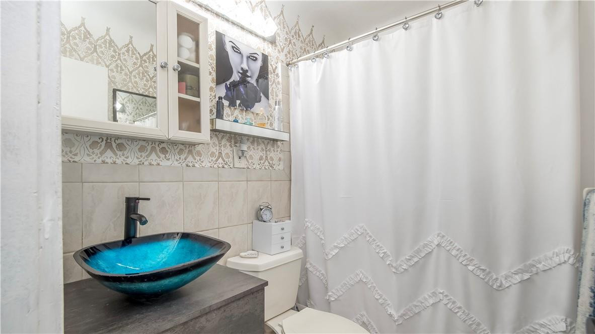 2221 Harding Street Hollywood, FL 33020 - Photo 13 of 30 a bathroom with a toilet and a mirror