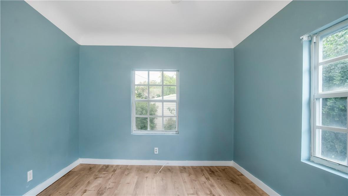 2221 Harding Street Hollywood, FL 33020 - Photo 15 of 30 an empty room with wooden floor and windows