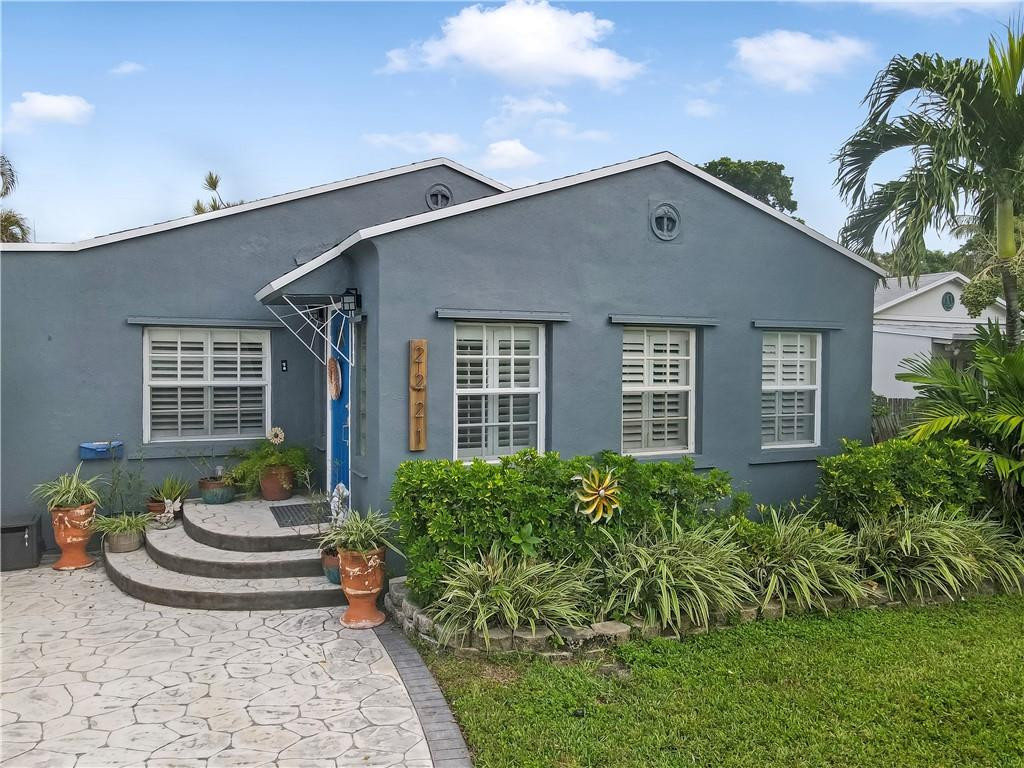 2221 Harding Street Hollywood, FL 33020 - Photo 2 of 30 a front view of a house with garden