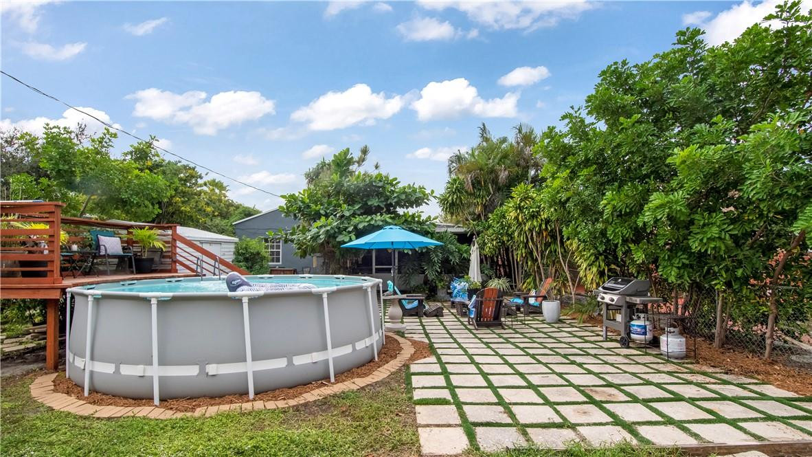 2221 Harding Street Hollywood, FL 33020 - Photo 24 of 30 a view of a patio with table and chairs potted plants and large tree