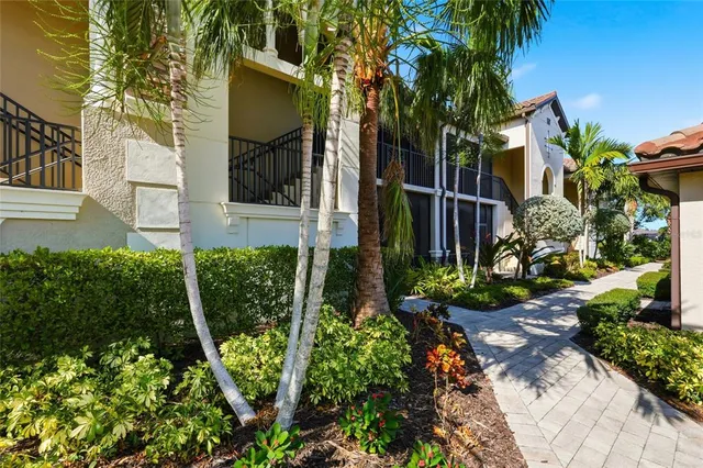 a front view of a house with a yard and potted plants