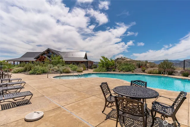 a view of a swimming pool and lounge chairs