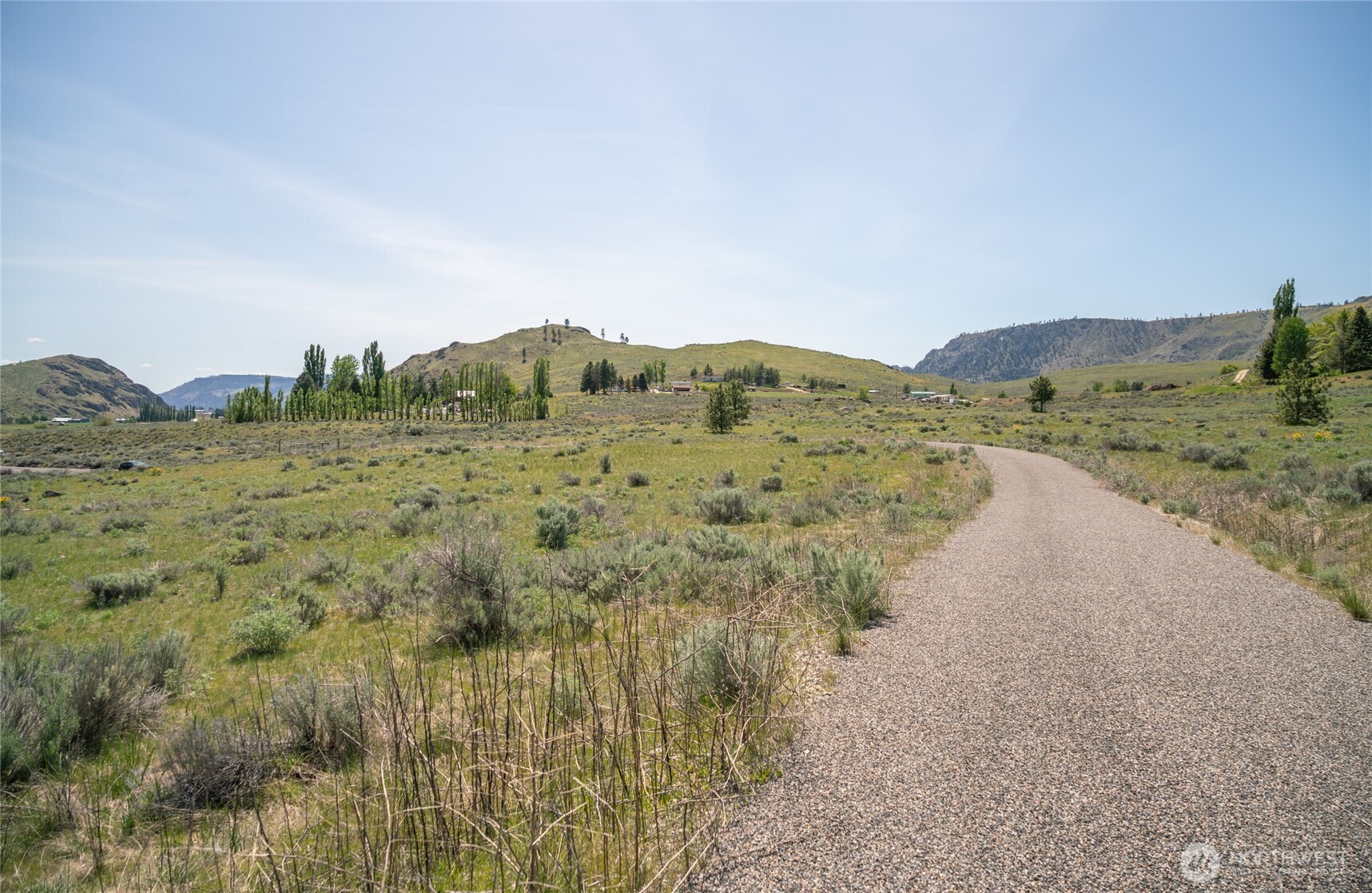 1 Gunsmoke Road Brewster, WA 98812 - Photo 4 of 29 a view of a dry yard with mountains in the background