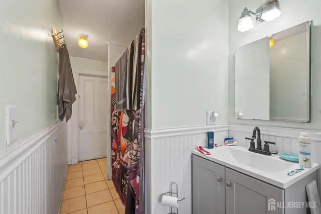 a bathroom with a sink vanity and a mirror