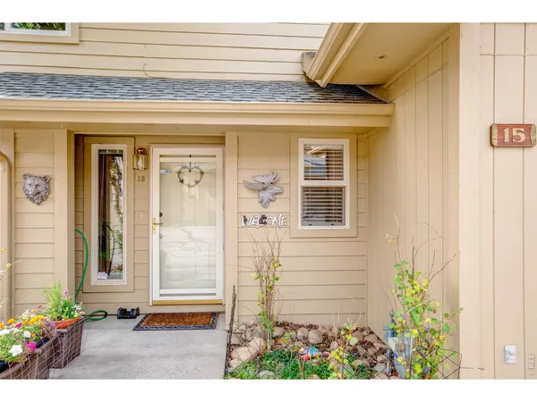 a view of a hallway with wooden floor and a living room