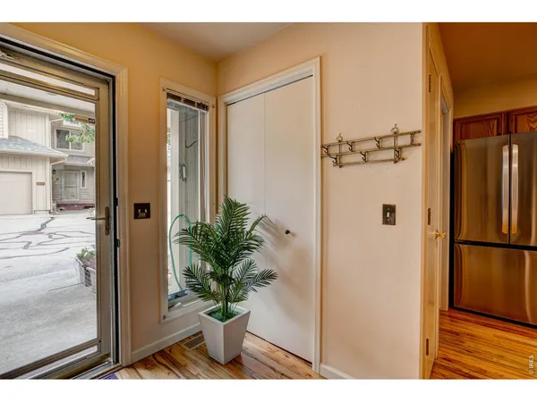 a view of entryway and hall with wooden floor