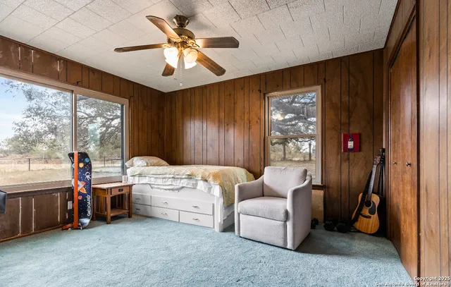 a bedroom with bed and a chandelier