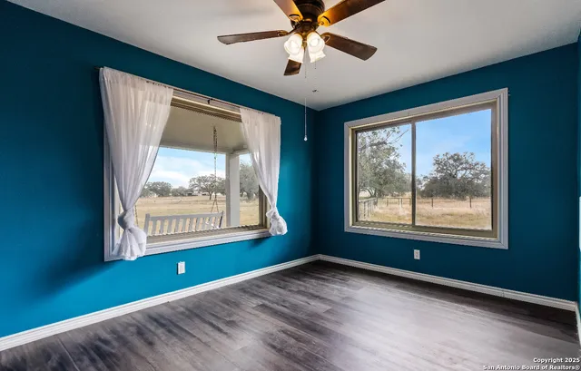 a bathroom with a granite countertop toilet sink and mirror