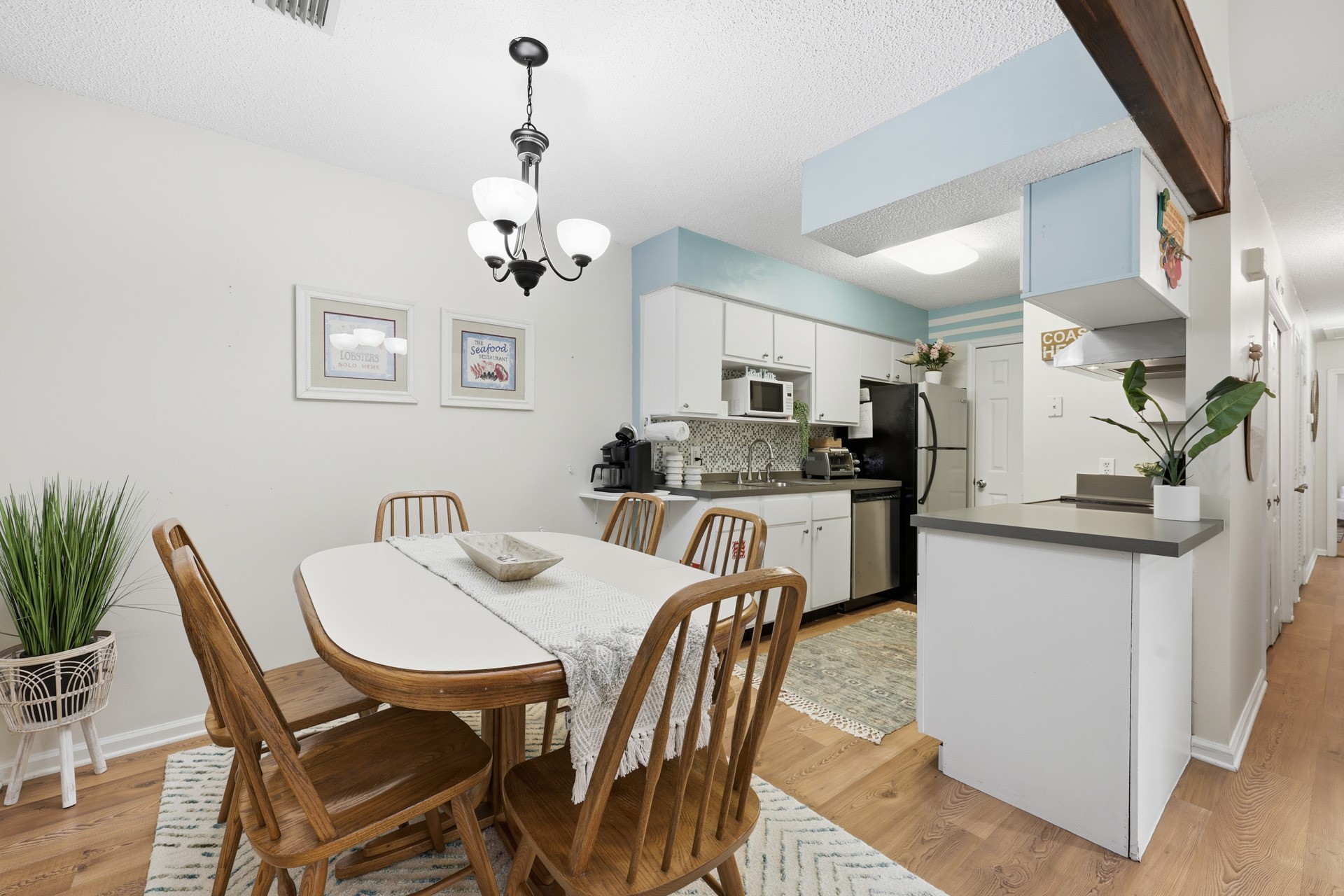 2886 Forest Ridge Drive, Unit U6 Fernandina Beach, FL 32034 - Photo 13 of 43 a kitchen with granite countertop a dining table chairs and white cabinets