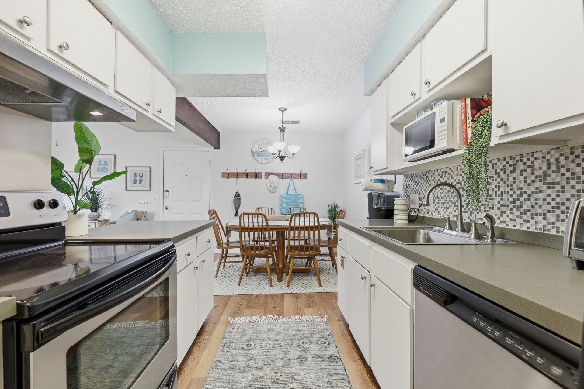 2886 Forest Ridge Drive, Unit U6 Fernandina Beach, FL 32034 - Photo 16 of 43 a kitchen with granite countertop a sink stove and cabinets