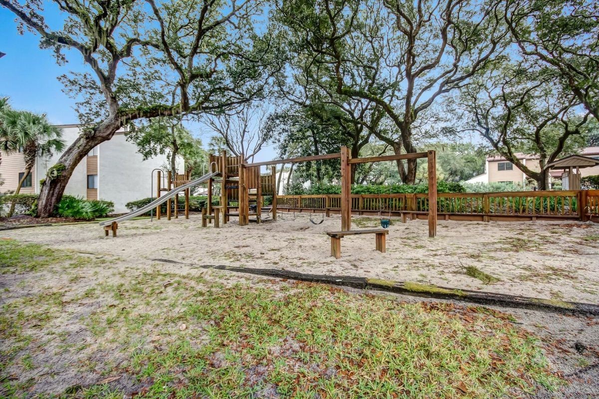 2886 Forest Ridge Drive, Unit U6 Fernandina Beach, FL 32034 - Photo 42 of 43 a view of a park with swings and a large tree