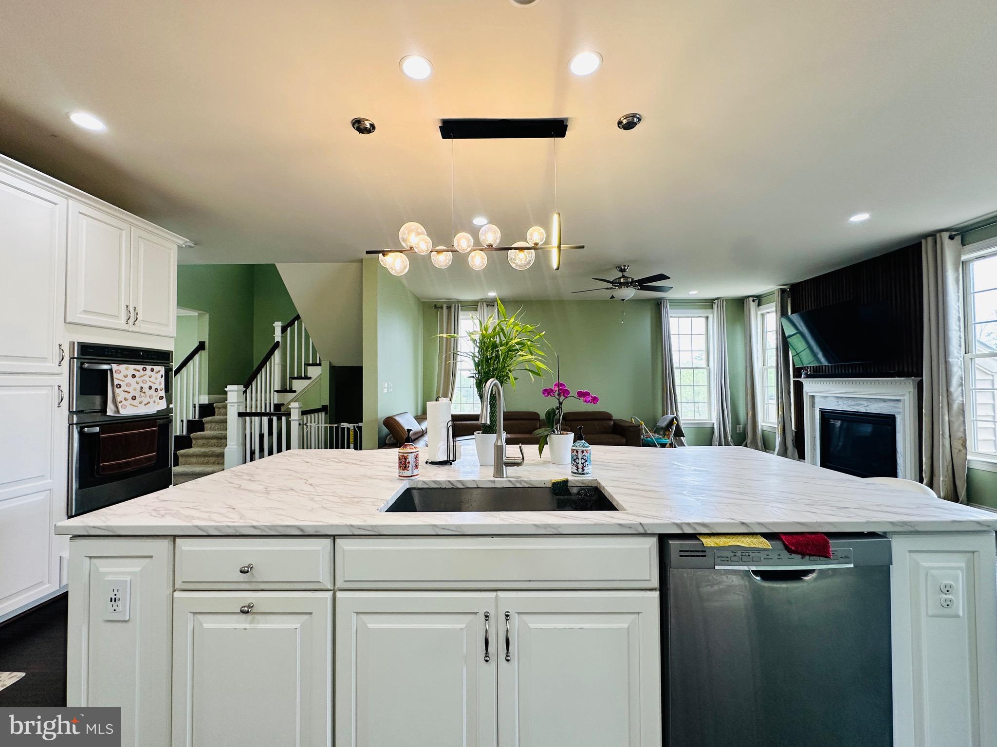 22611 Windsor Locks Square Ashburn, VA 20148 - Photo 13 of 53 a kitchen with kitchen island a counter top space a sink and appliances