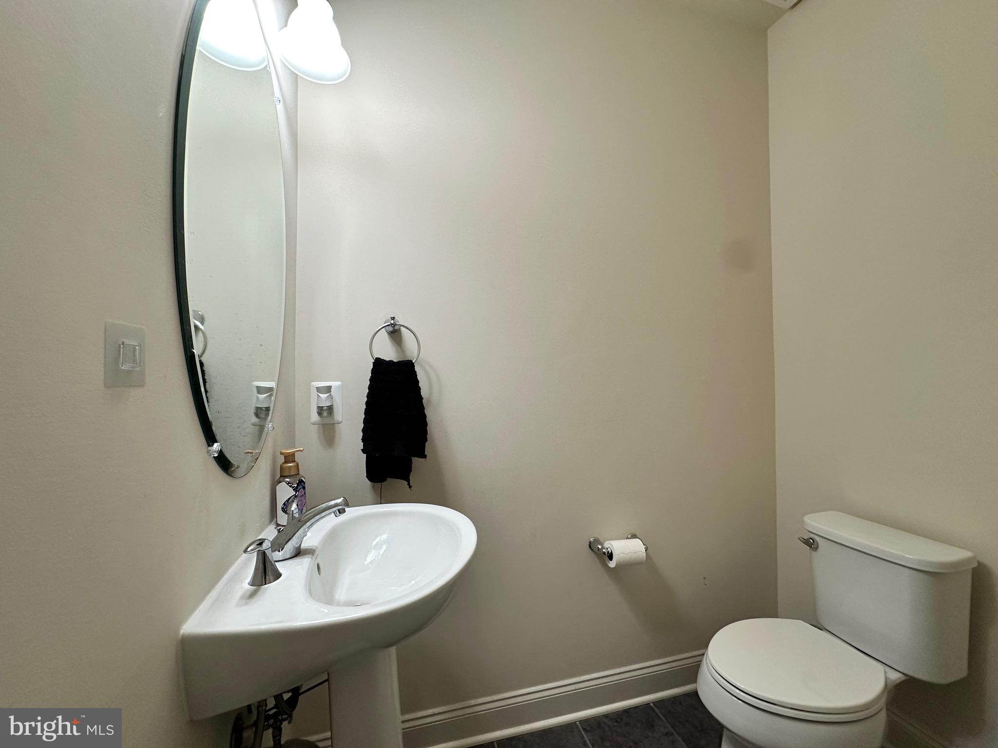 22611 Windsor Locks Square Ashburn, VA 20148 - Photo 18 of 53 a bathroom with a sink a toilet and mirror