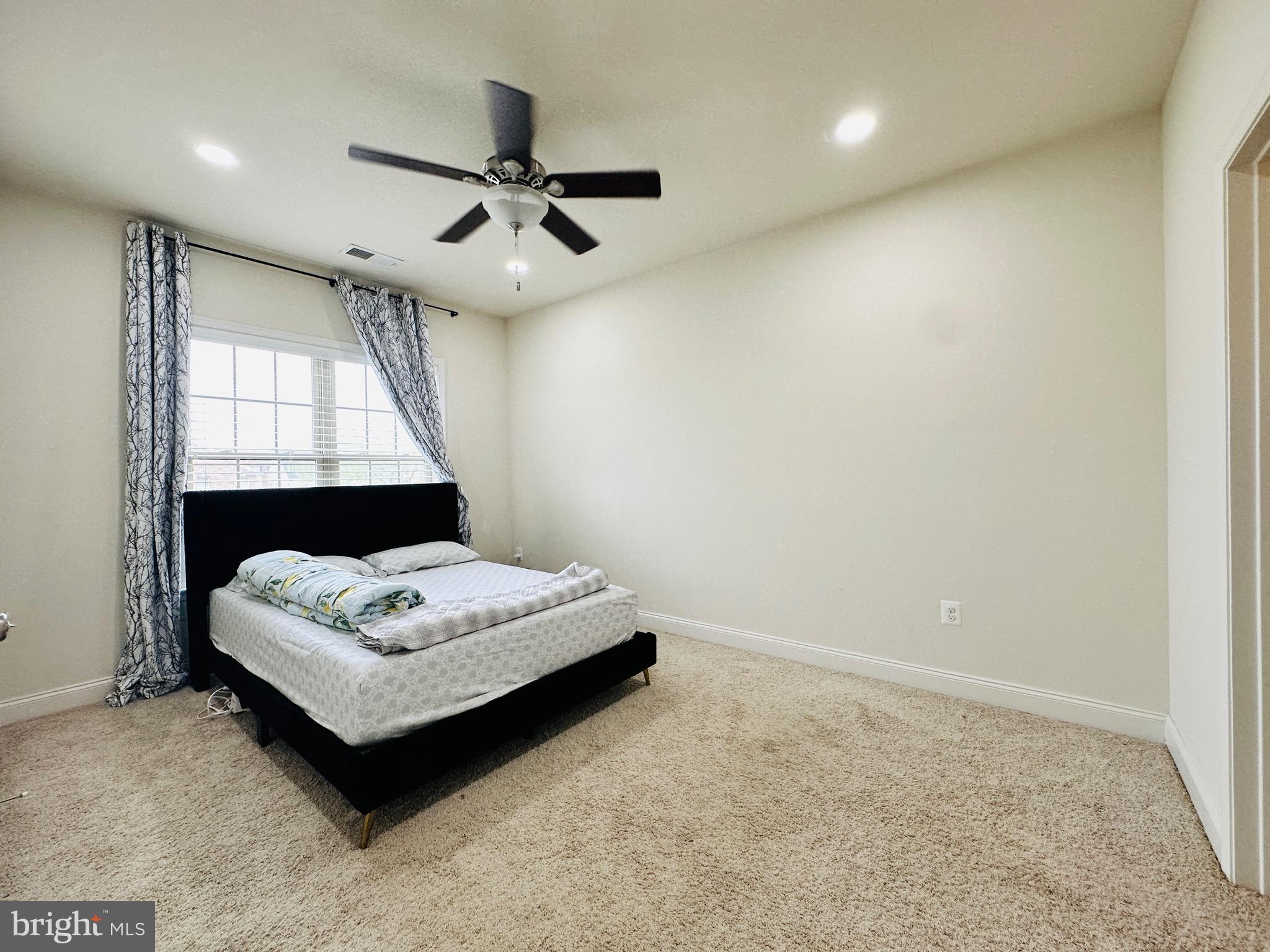 22611 Windsor Locks Square Ashburn, VA 20148 - Photo 19 of 53 a spacious bedroom with a bed and a window