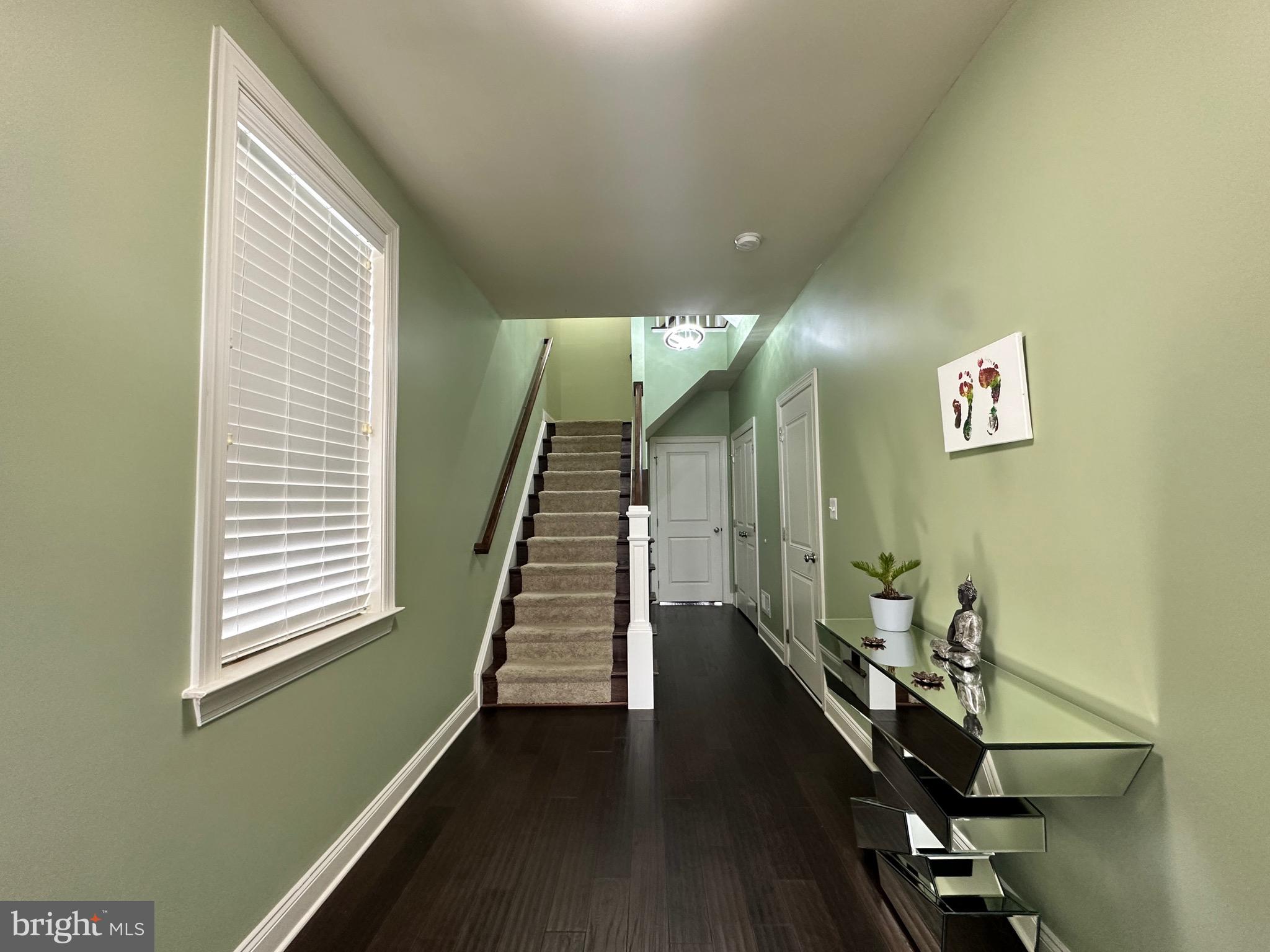 22611 Windsor Locks Square Ashburn, VA 20148 - Photo 2 of 53 a view of a hallway with wooden floor and stairs