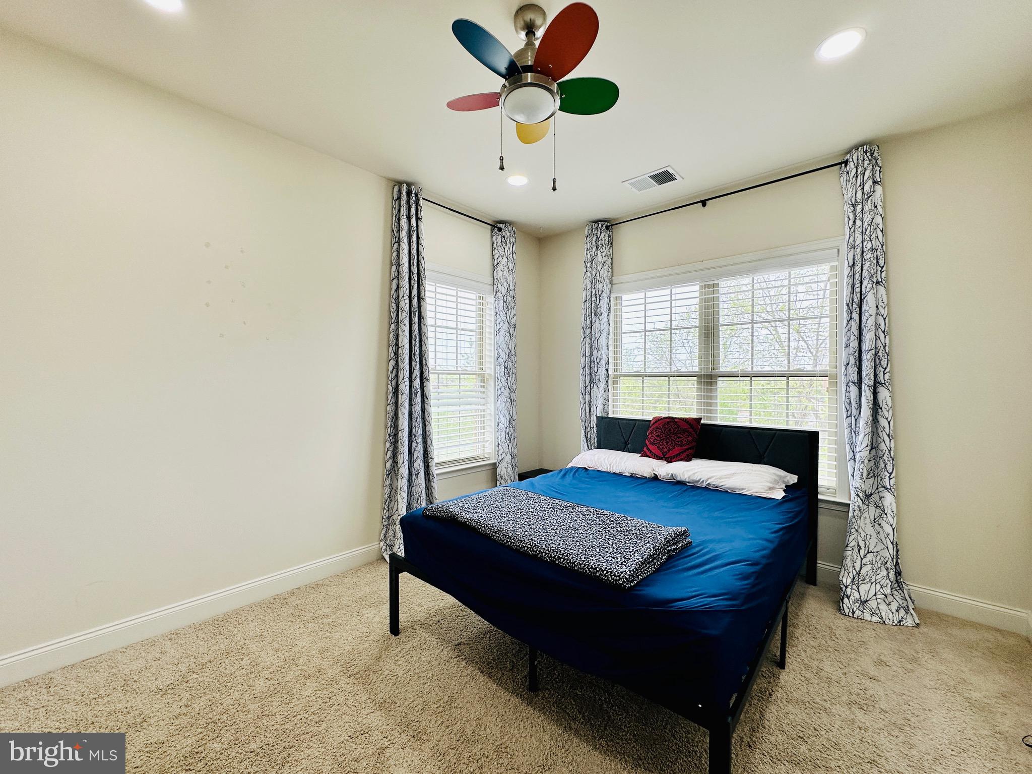 22611 Windsor Locks Square Ashburn, VA 20148 - Photo 25 of 53 a bedroom with a bed and a chandelier