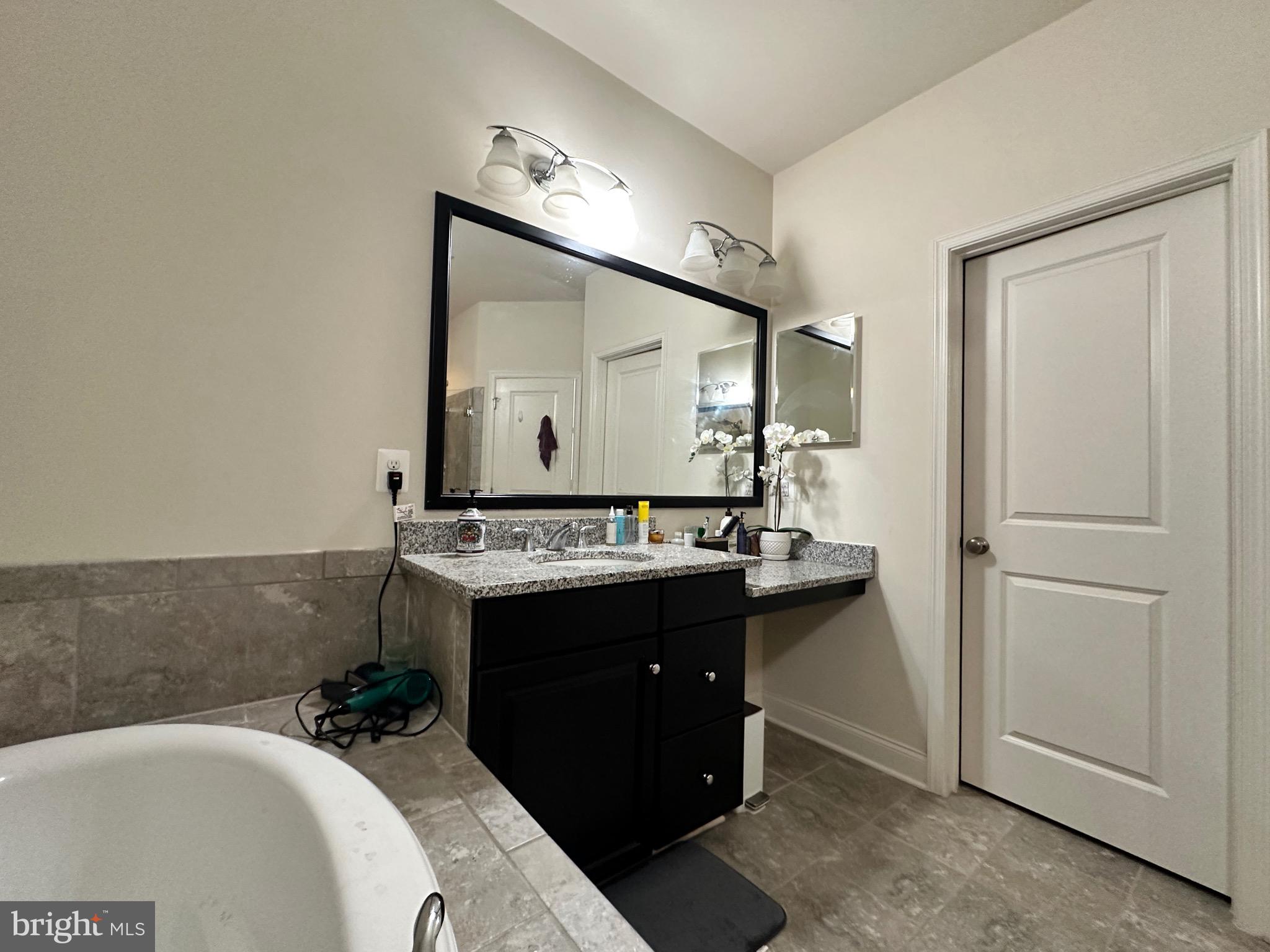 22611 Windsor Locks Square Ashburn, VA 20148 - Photo 32 of 53 a bathroom with a sink and a mirror
