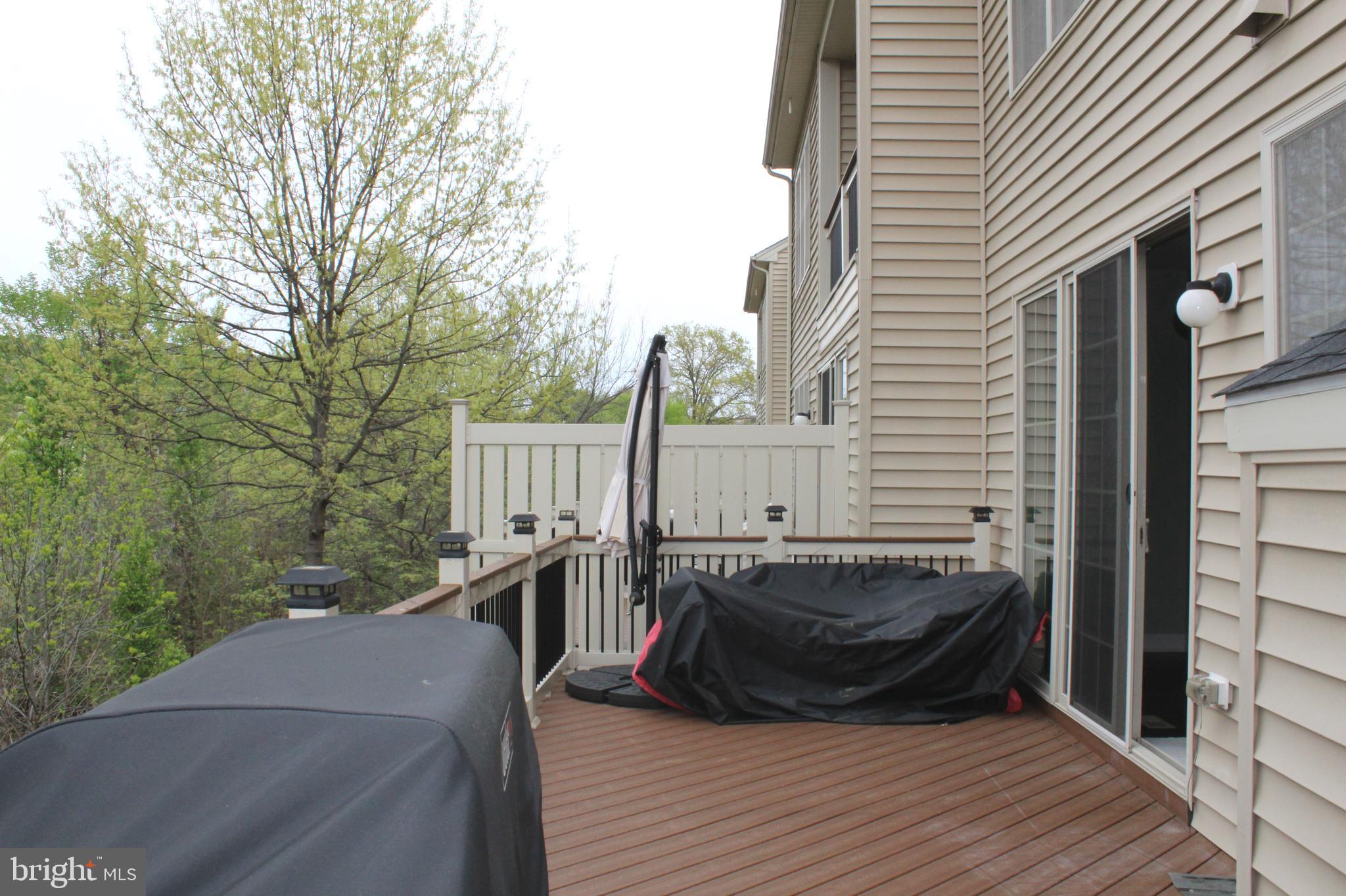 22611 Windsor Locks Square Ashburn, VA 20148 - Photo 49 of 53 a view of a balcony with two chairs and wooden floor