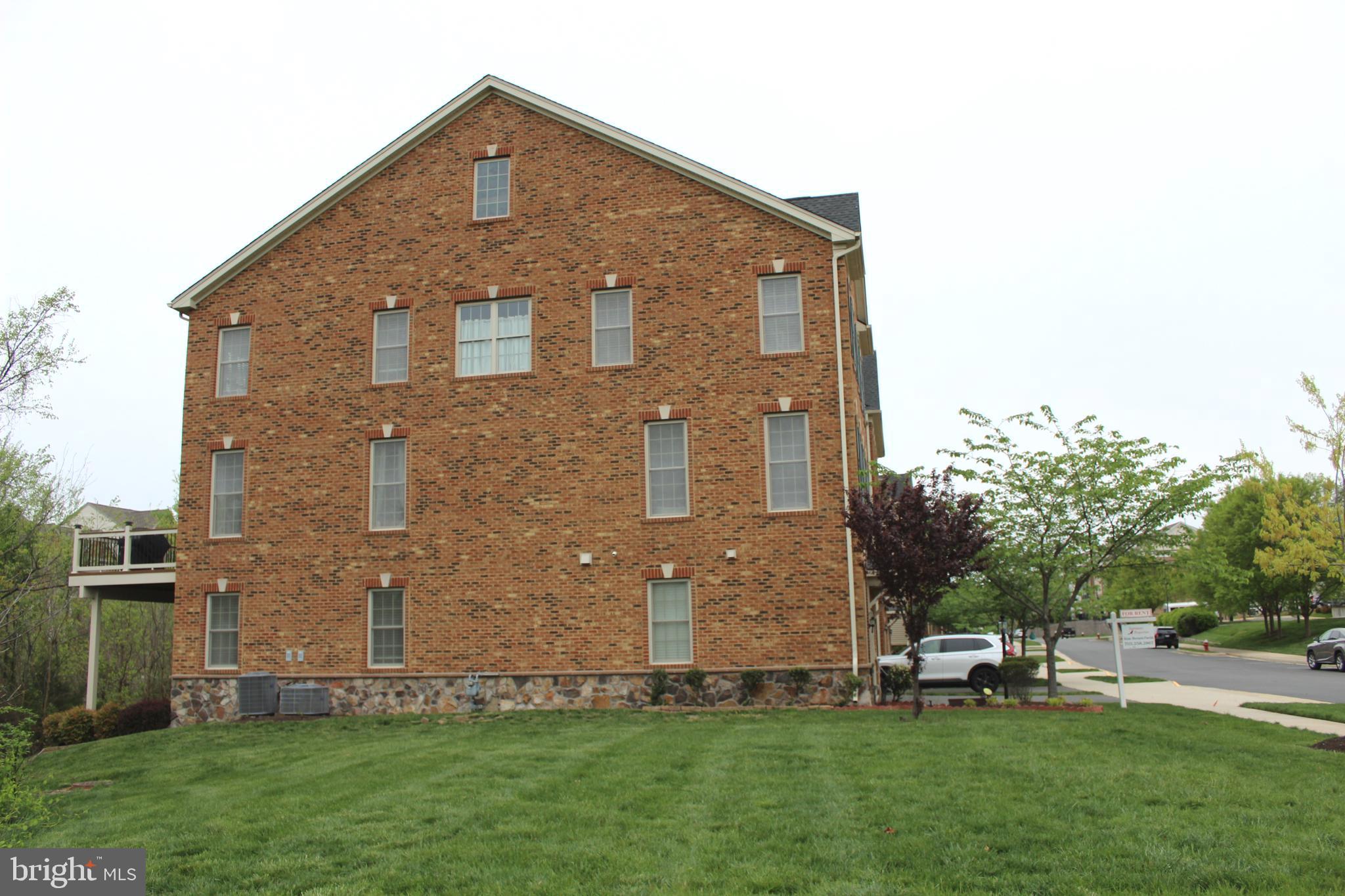 22611 Windsor Locks Square Ashburn, VA 20148 - Photo 51 of 53 a front view of a house with a yard